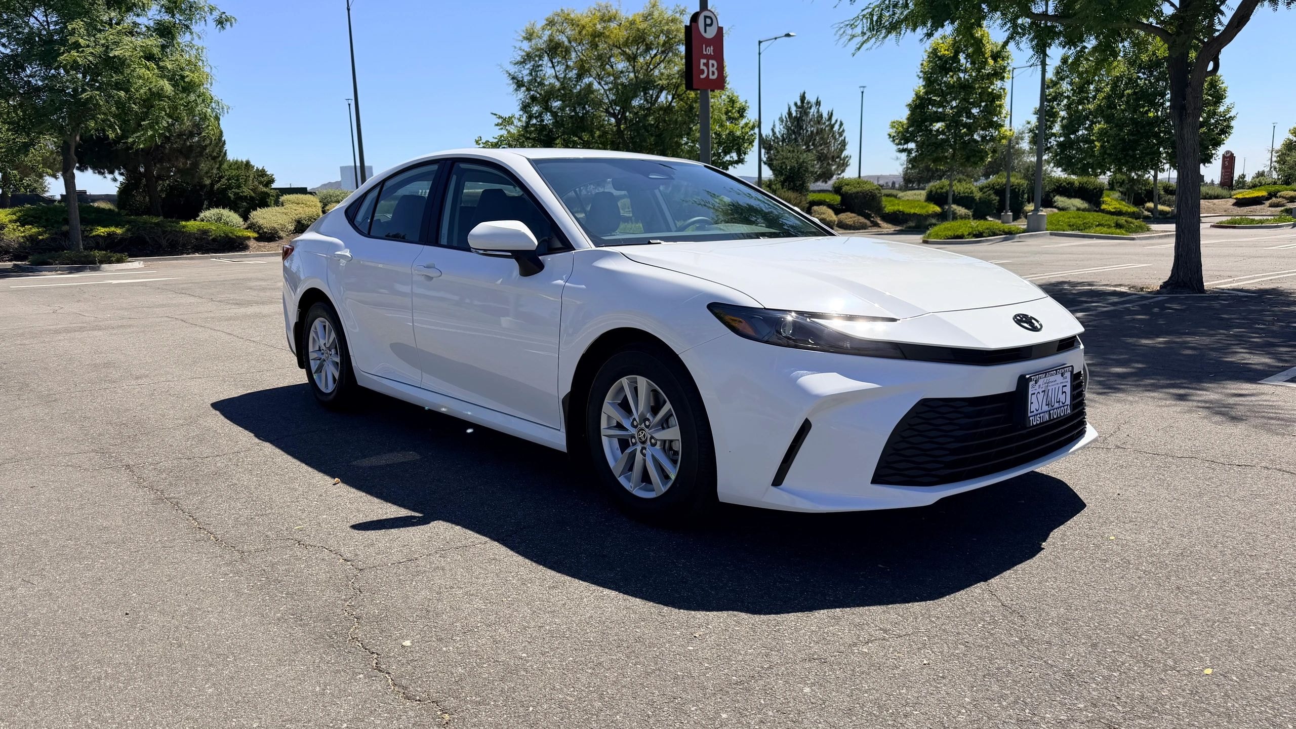 White Toyota Camry sedan available for rental